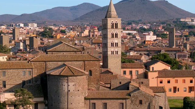 Viterbo Italy Aerial View of San Lorenzo Cathedral and Papal Palace. Cinematic Drone Flyby of Gothic Campanile and Palazzo dei Papi with Monte Cimino Background, Medieval Architecture of Tuscia, Lazio
