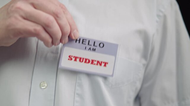 Close view of student identification badge pinned to attire