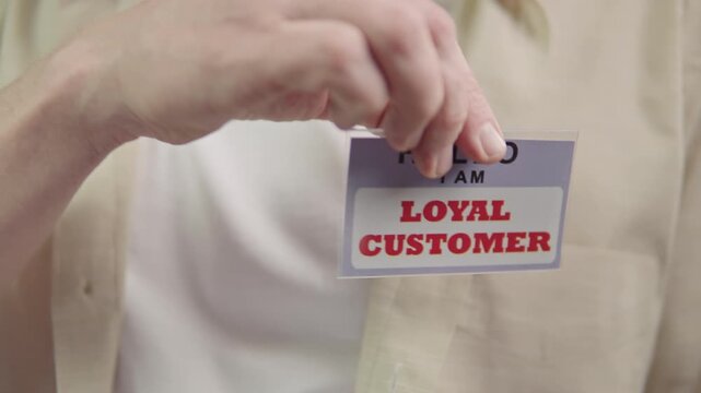 loyal customer badge on chest person.Retail scene with customer displaying loyalty and reward badges clearly