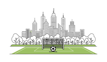 A soccer field with a goal and ball in front of a city skyline with skyscrapers and trees © Lsg 21