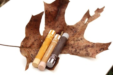 Close up of Oil Pastels on a leaf on a drawing pad