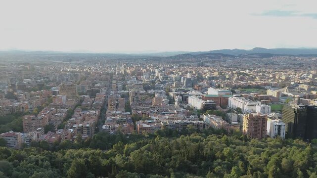 Pan aerial footage of natural mountain scenary at golden hour flare