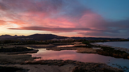 Panoramic sunset over Li Salineddi Pond in Budoni, Sardinia, Italy.