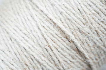Fototapeta premium Large ball of white fluffy yarn, close-up texture of soft woolen thread for knitting 