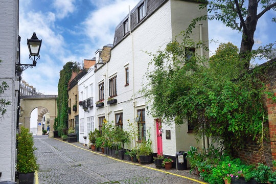 Cobblestoned alley with narrow mews houses in Kensington area of London, England