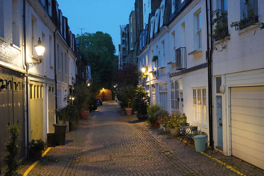 Cobblestoned alley with mews houses in Kensington area of London, England
