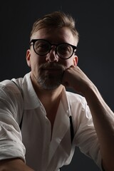 Obraz premium Portrait of handsome man on dark grey background
