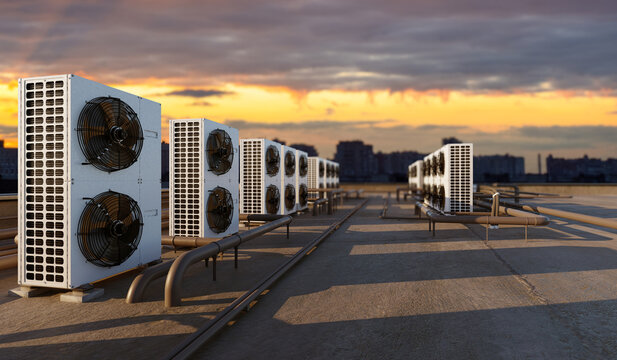 Building engineering, HVAC systems. Rooftop air conditioning units operate on commercial building, providing climate control, ventilation, and cooling for urban infrastructure.