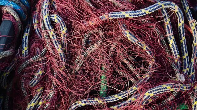 Tangled fishing nets and ropes forming a colorful abstract pattern for maritime themes