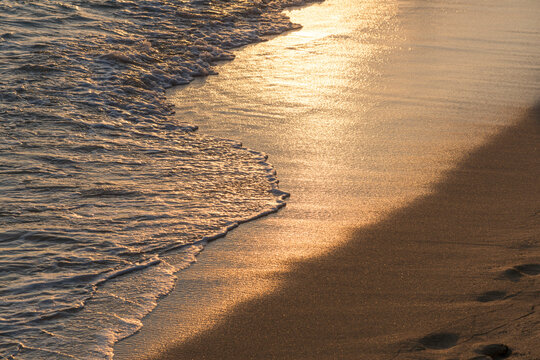 USA, Hawaii, Honolulu, Waikiki.  Waves lapping on the shore in the quiet of dusk.