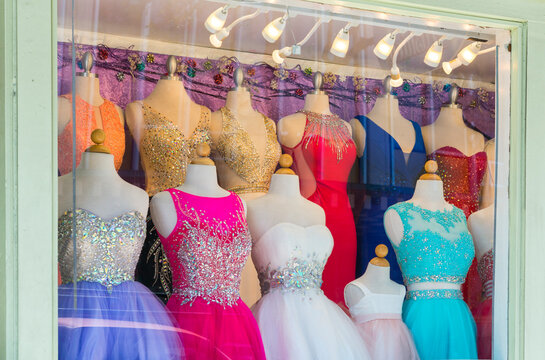 USA, Hawaii, Oahu, Honolulu.  Fancy prom dresses displayed in shop window.