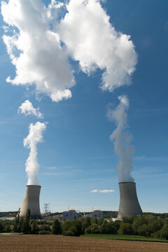 EU, France.  Nuclear power plant cooling towers with steam rising.