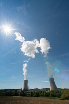 EU, France.  Nuclear power plant cooling towers with steam rising.