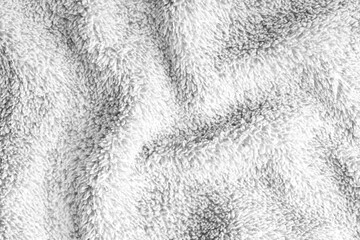 Close up, macro of crumpled white terry towel fabric with wrinkles and soft waves. Fluffy microfiber texture with dense fibers, textile, material structure, detailed cloth abstract background © katyamaximenko