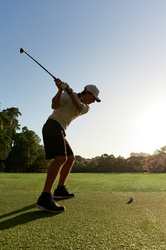 Golfer's Silhouette Against the Sun