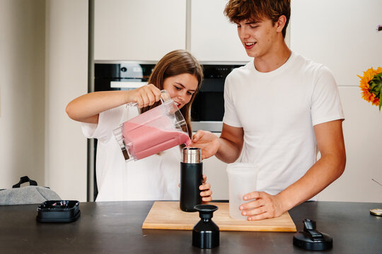 Friends serving fruity smoothie in reusable, no waste cups
