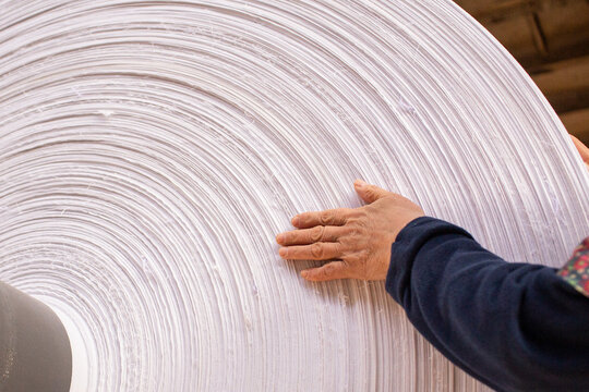 a large bobbin of ready-made white cotton fabric