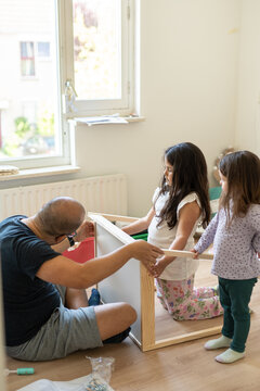 Dad teaching furniture assembly
