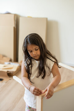 Girl assembling furniture