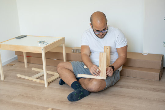 Dad teaching furniture assembly
