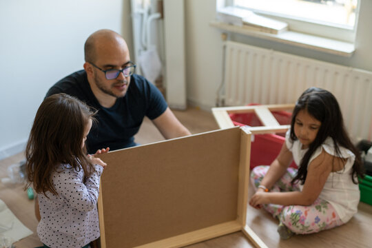 Dad teaching furniture assembly