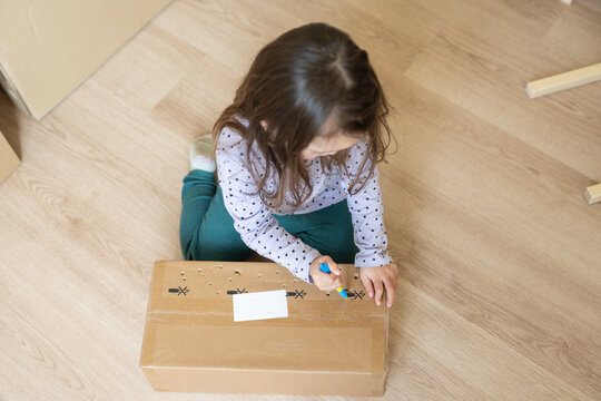 Little girl playing with a box