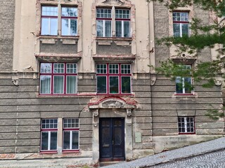 Historic facade with weathered details. Aged architectural structure displaying wear and decay © Vladimir