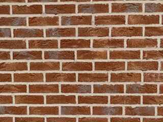 Fototapeta premium Weathered mortar on city wall. Industrial textured wall with warm tones and gritty appearance