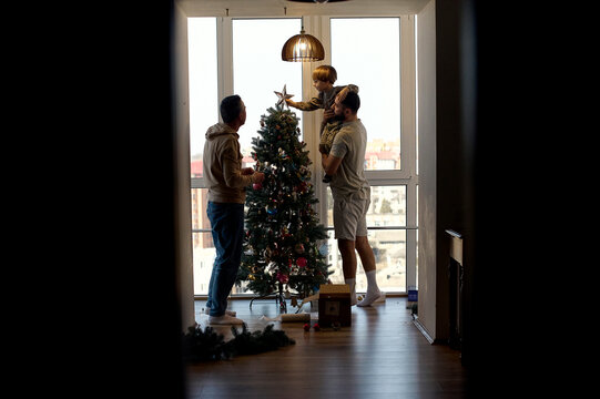 happy family decorate the Christmas tree