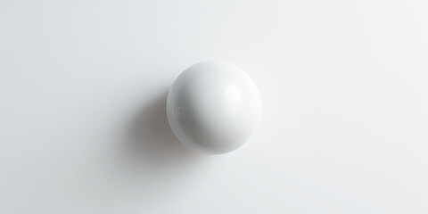 Minimalist white sphere on a clean surface.