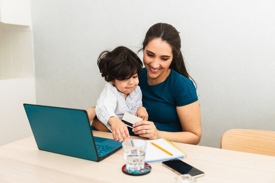 Pregnant woman making online purchase on a laptop