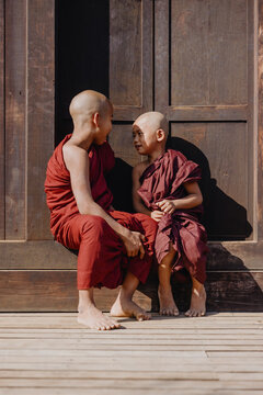 Novice monks conversing outside temple