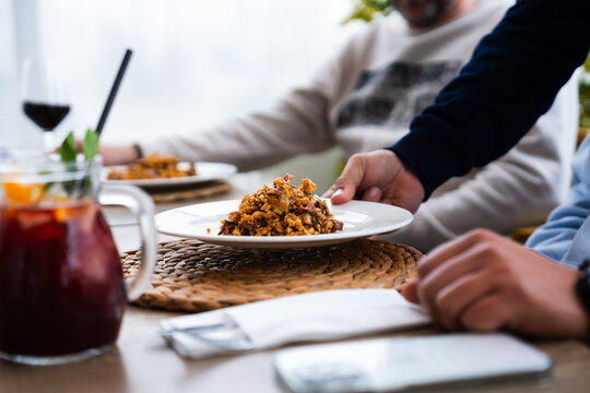 Serving delicious paella at a family gathering