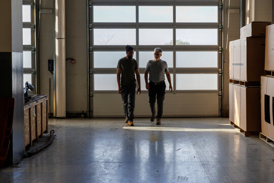 Multiracial coworkers walking in industry