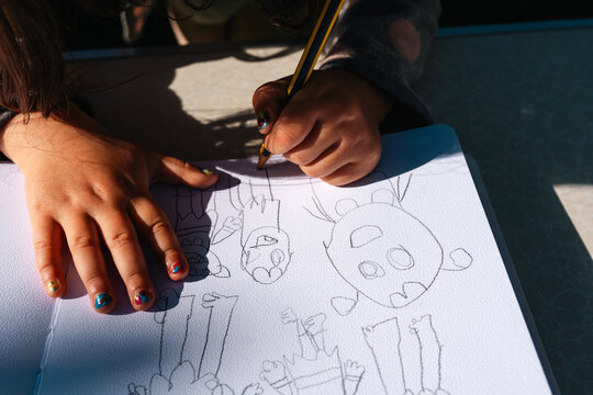 Child Drawing monsters with pencil