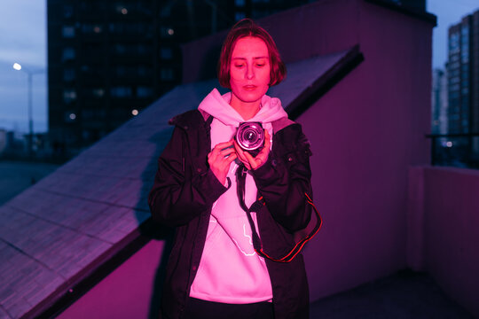 Non binary person with camcorder on the street