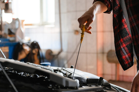 A man repairs a car in the garage