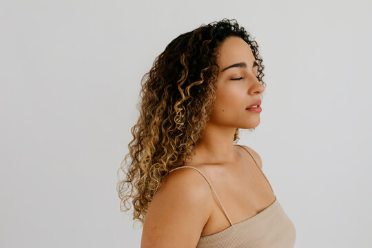 Portrait of dreamy woman standing in studio