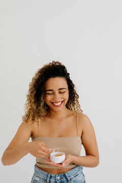 Model with container of natural beauty cream