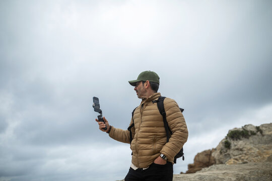 traveler man using mobile phone outdoors