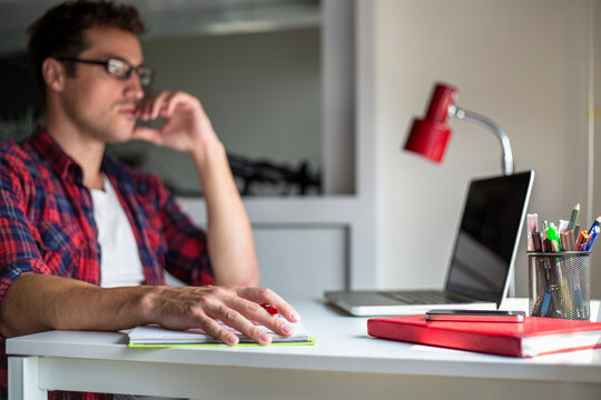 Young man thinking at the desk