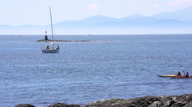 Victoria, British Columbia, Canada &ndash; July 25, 2021. Kayaking in Haro Strait Oak Bay 4K UHD. Kayaking and boating on smooth water off Cattle Point near Victoria. British Columbia, Canada. 4K, UHD.
