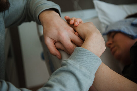 Gentle hand-holding in maternity ward