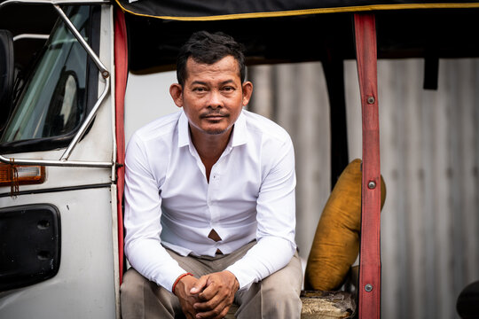 Portrait of a Tuk Tuk taxi driver on a street in Phnom Penh, Cambodia