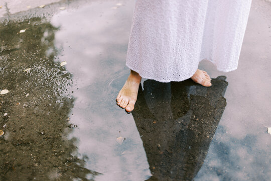 young woman standing in the puddle