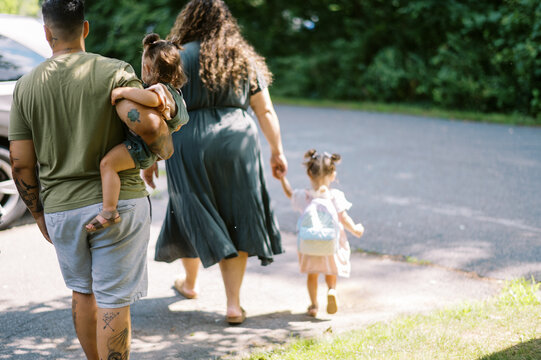 family going to car to leave together
