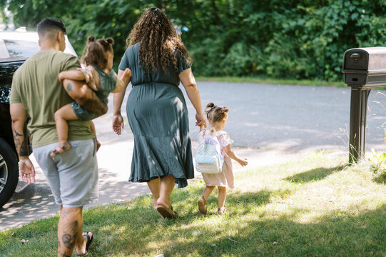 family going to car to leave together