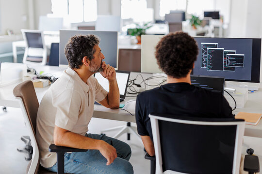 Software developers team working on project using computer in office