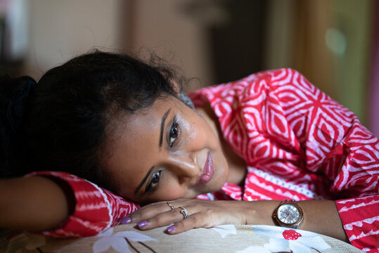Indian woman lying and bed and thinking