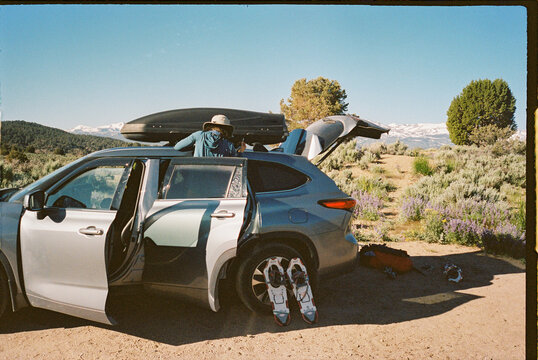 Woman prepping car for roadtrip